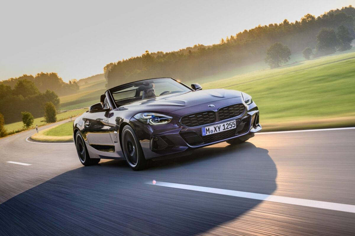 BMW roadster Z4 violette en train de rouler sur route de campagne
