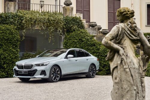 Voiture BMW Série 5 stationnée devant une demeure élégante, symbole de confort et de performance sur autoroute, idéale pour les longs trajets